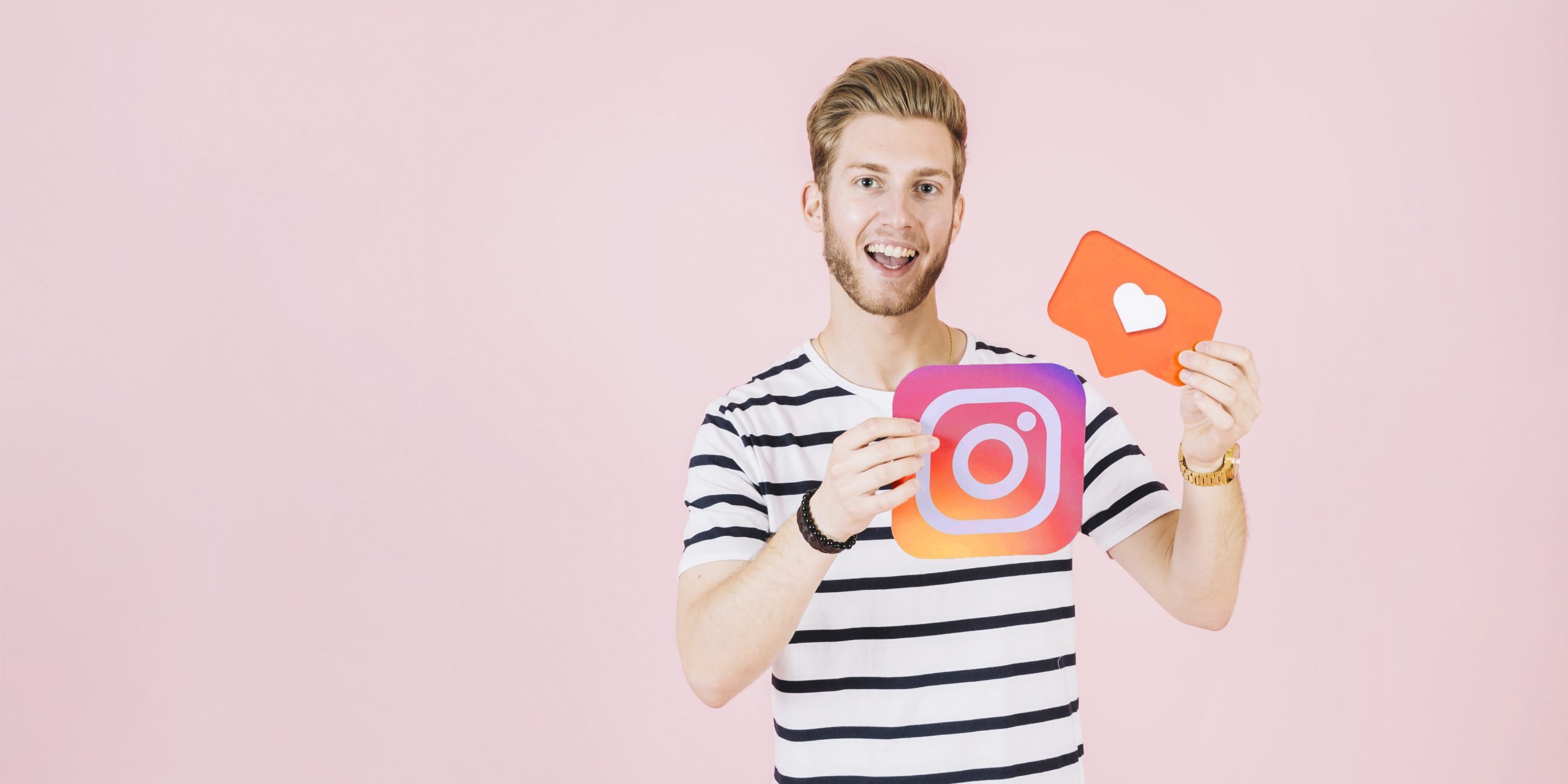 portrait-happy-young-man-holding-instagram-like-icon اینستاگرام مارکتینگ